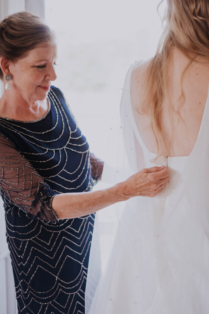 Mother of the Bride helping Bride