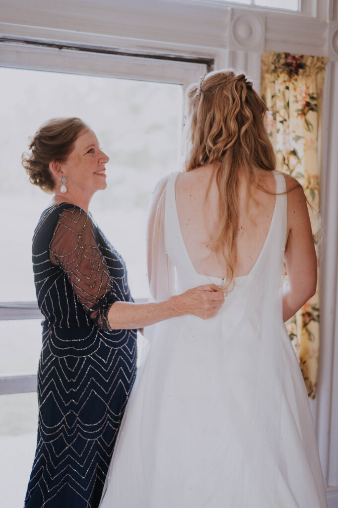 Mother of the bride helping bride