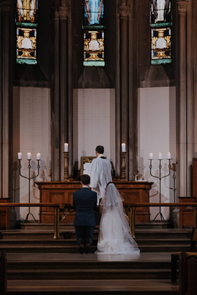 Bride & Groom praying at wedding