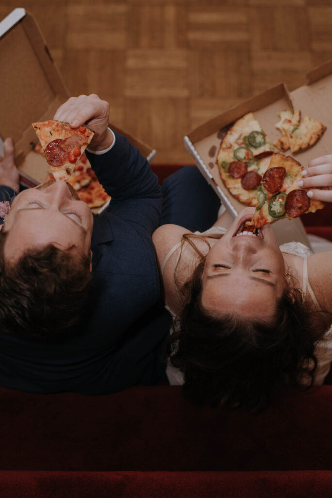 Bride & Groom eating Pizza at wedding