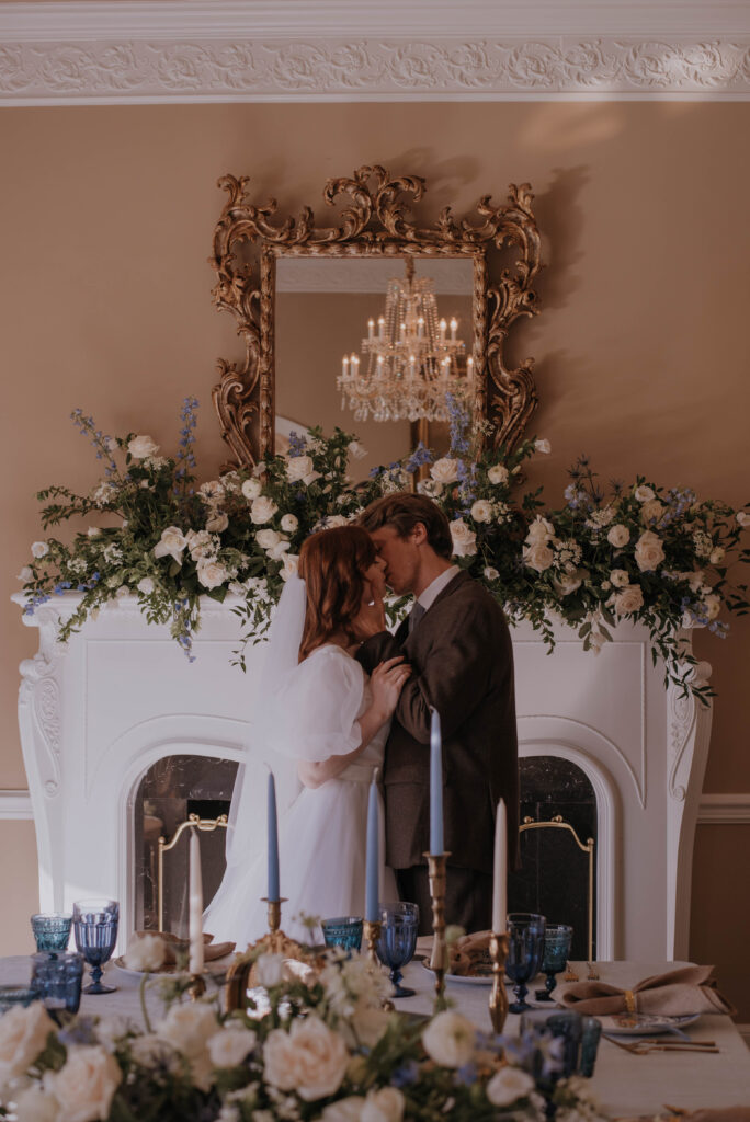 bride and groom kiss inside wedding reception