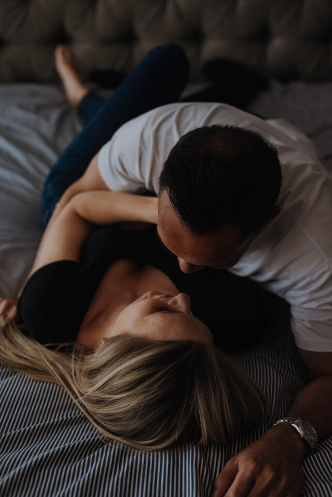 Couple cuddling on bed