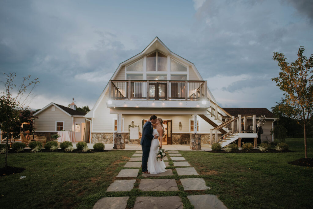 bride and groom kiss outside of Halcyon Watson wedding venue in VA