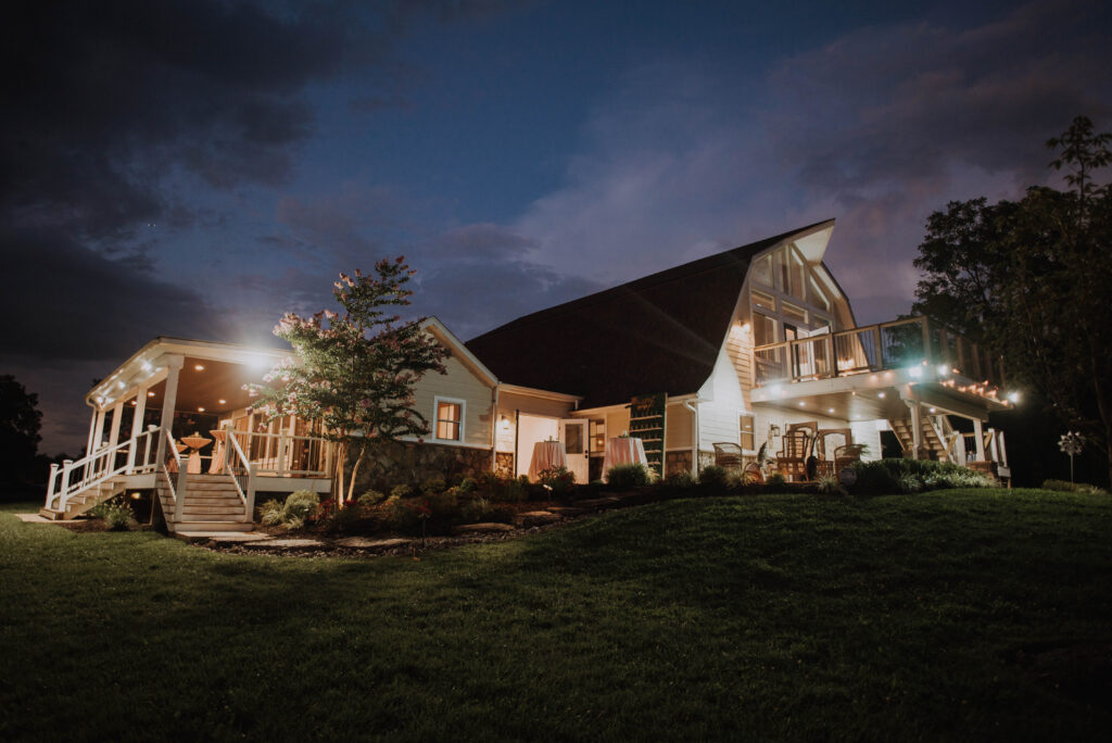 Halycon Watson barn wedding venue at night with lights on