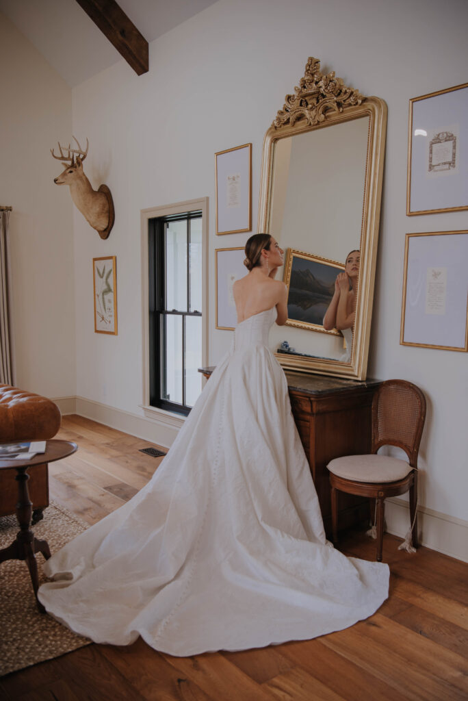 Bride looking at herself in the mirror